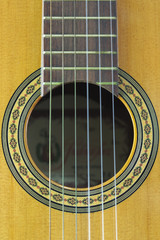 Obraz premium Close-up of the soundhole in the box of a Spanish guitar