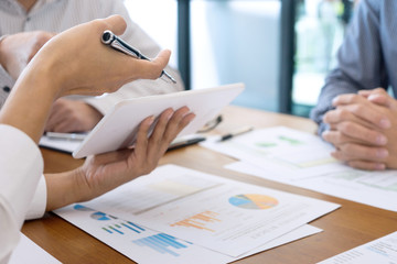Group of teamwork businessman and woman in the meeting work to analysis marketing data concept business discussion