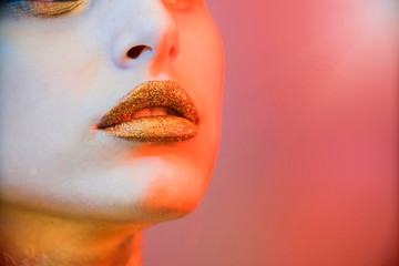 closeup of a make-up lips gold