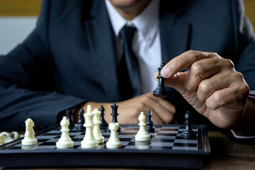 Businessman play chess how  to crash overthrow the competitor