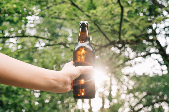 Holding Cold Beer At Garden In Hot Summer Evening