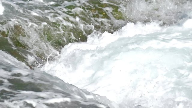 beautiful oceanic waves with white dense foam on summer day slow motion close view. Concept tsunami impact and ecosystem change