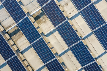 Obraz premium Top view of blue shiny solar photo voltaic panels system producing renewable clean energy abstract background.