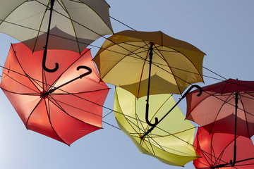 Multicolored umbrella street decoration on blue sky background