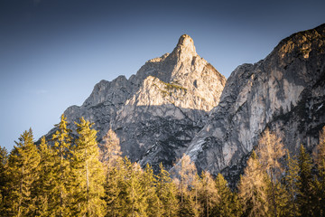 beautiful snowy mountains in sunlight with blue sky in dolomites, italy