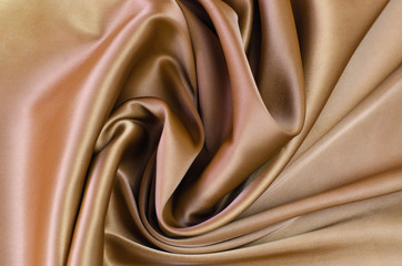 Background from satin fabric of brown color.