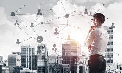 Concept of business success and control with confident boss against cityscape background