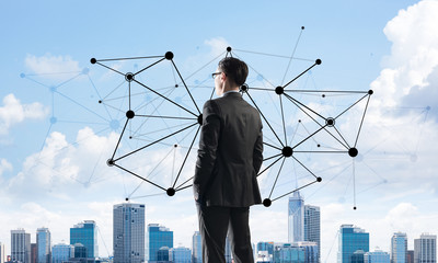 Concept of business success and control with confident boss against cityscape background