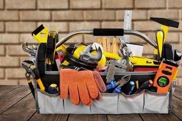 Gloves and tools on wooden background