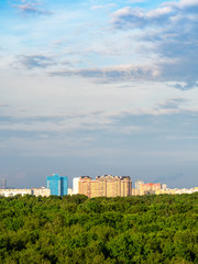 Fototapeta na wymiar evenig sky over city park and residential houses