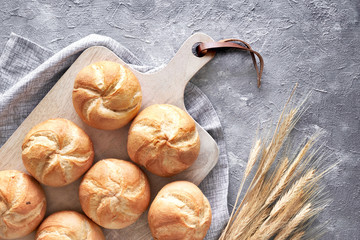 Crusty round bread rolls, known as Kaiser or Vienna rolls on linen towel