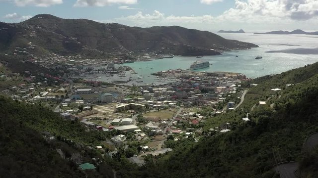 Scenic aerial view of capital of British Virgin Islands Tortola. Beautiful sunny summer landscape of little tropical islands in Caribbean sea. Look of port of small town on green hills.