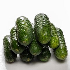 Beautiful young cucumbers on a white background