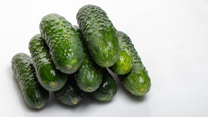 Beautiful young cucumbers on a white background