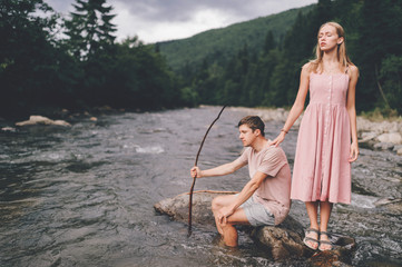 Lifestyle loving couple posing in the river at nature.