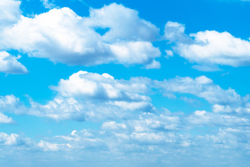 many white fluffy clouds in blue sky in May