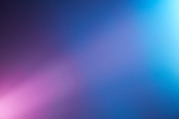 Short light pink ray of light on blue and turquoise background