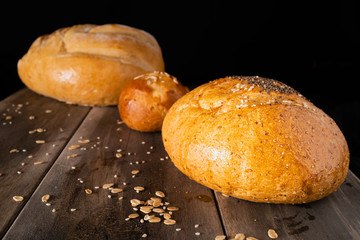 Three loaves on an old wooden table