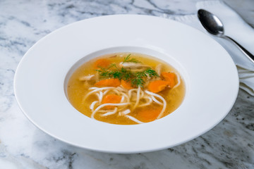Chicken soup bouillon in a plate