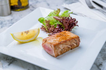 grilled tuna fillet with vegetables and lemon