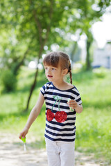 Fototapeta premium Adorable little girl blowing bubble