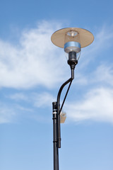 Lamppost on a cloudy sky background