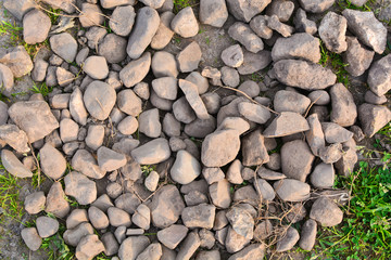 Brown stones background. Natural stones for background. Many stones lying on the ground. Abstract background.