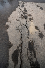 Puddles and cracks of the asphalt