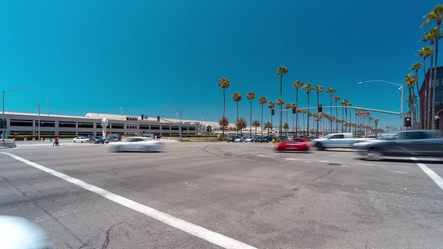 Time lapse at a busy street intersection in Irvine, California with blurred traffic or cars driving by.