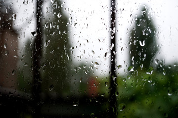 raindrops on window pane, overcast gloomy weather
