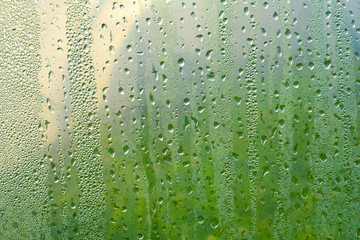 Wet transparent plastic film with drops of water after rain. Water drops close up. Rainy background. Rainy weather abstract background