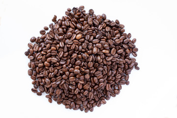 Pile of coffee beans on white background. Top view. Close up image.