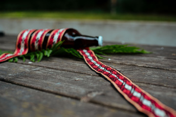 Latvian beer with traditional folk belt
