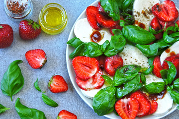Summer caprese salad. Caprese with strawberries. Dietary salad with basil and mozzarella. Keto diet.