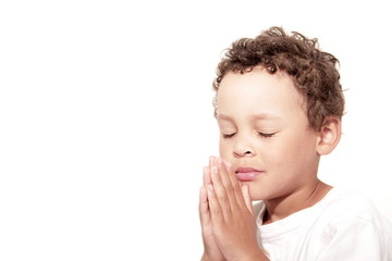 little boy praying to God stock image with hands held together with closed eyes  stock photo