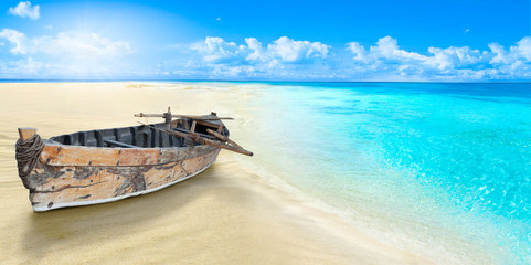 Old fishing boat on the seashore. Sandy beach. - Powered by Adobe