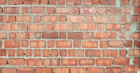 Red brick wall rough in construction texture for background