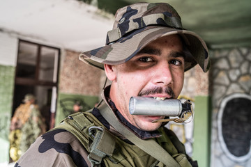 Dogs of war soldier war criminal terrorist holding grenade in his teeth mouth soldier battle front...