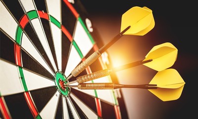 Dartboard with arrows on ackground
