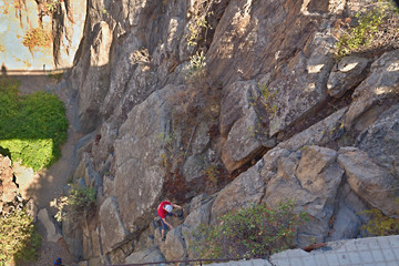 a steep wall climber on the descent can be seen from above in tenerife Arico