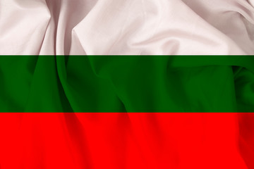 Obraz premium beautiful national flag of Bulgaria on soft silk with soft folds, close-up, copy space