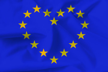 stylized European Union flag, symbol of united Europe, heart on soft silk with soft folds, close-up, copy space