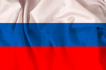beautiful national flag of Russia on soft silk with soft folds, close-up, copy space