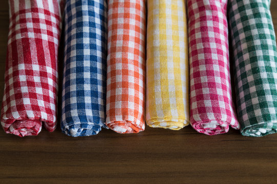 colorful,yellow,blue,orange,pink,red,green German napkins on the wooden table.