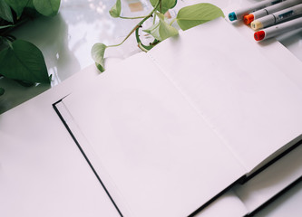 composition notebook with plant and markers. mockup. flat lay. top view