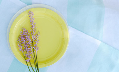 Organic summer concept with linen and yellow plate for picnic.