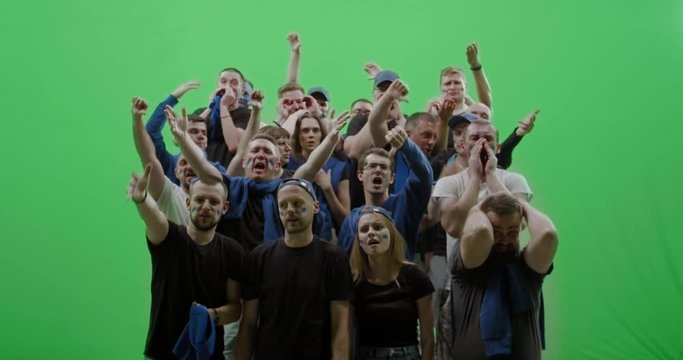 GREEN SCREEN CHROMA KEY Front view group of people fans wearing blue clothes are outraged during a sport event. 4K UHD ProRes 422 HQ