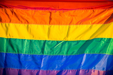 Rainbow flag fills the frame for a colorful background of gay pride, inclusiveness, and tolerance
