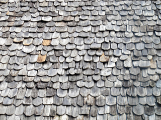 close up weathered wooden roof tile of old building