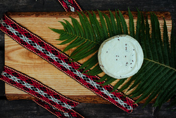 Latvian cheese with fern and national belt